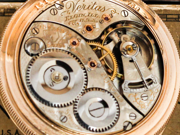 A close up of the movement of the Elgin Grade 239 showing the serial number, the jewel count and some fine engravings on the movement.