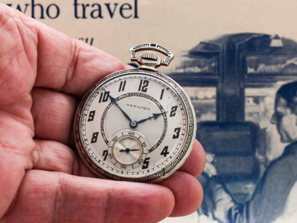 Hamilton dress pocket watch depicted in a model's hand giving scale to the size 12 timepiece